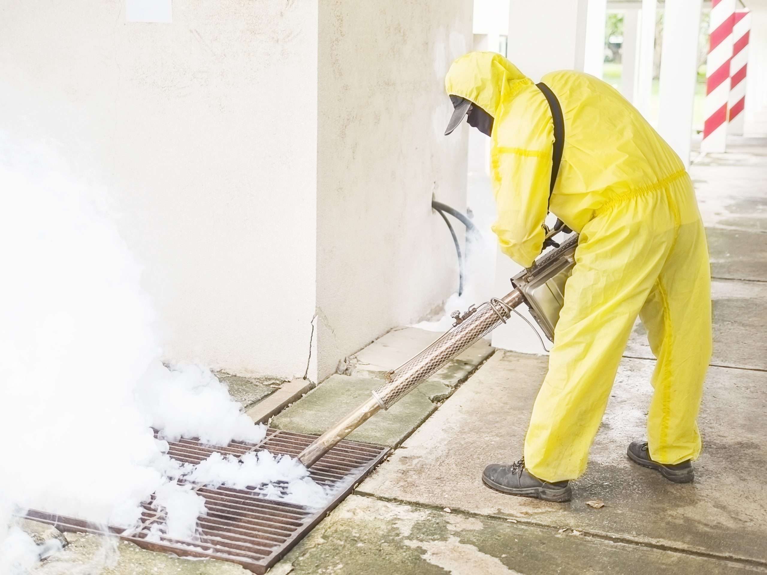 man is using thermal fog machine to protect mosquito spreading